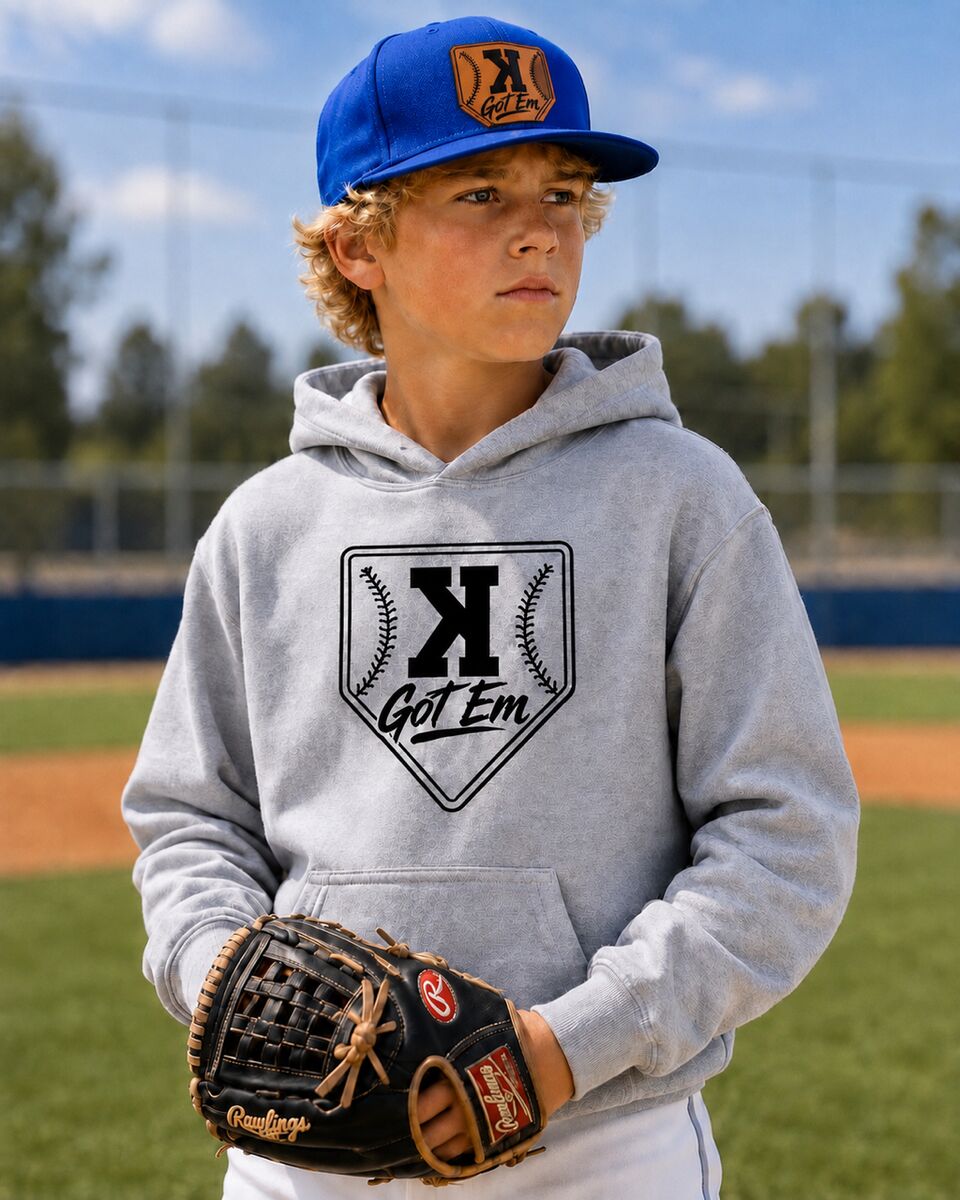 Player in the grey Got 'Em hoodie and royal blue hat with a glove