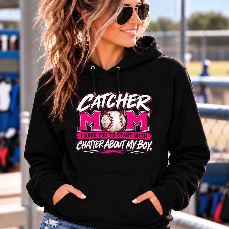 A mom in the black Catcher Mom hoodie with the pink print